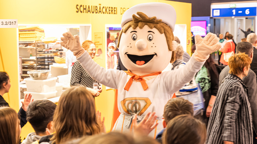 Kinder und Jugendliche werden am Messestand der Deutschen Innungsbäcker vom Maskottchen Bäckman empfangen. Am Stand bekommen interessierte Jugendliche und deren Elten Informationen über die Jobs- und Karrierechancen im Bäckerhandwerk. Foto: Zentralverband